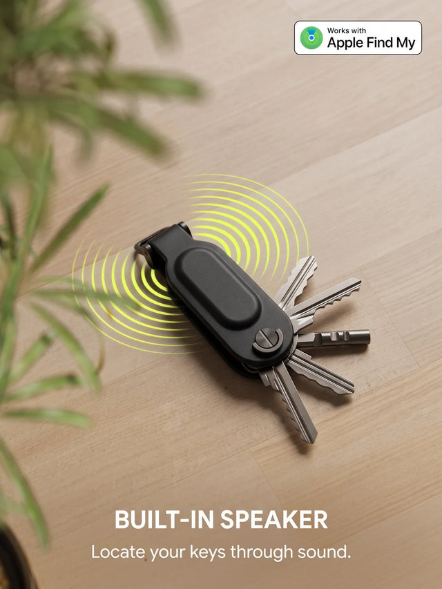 Key organizer with built-in speaker ringing on a wooden floor to locate lost keys